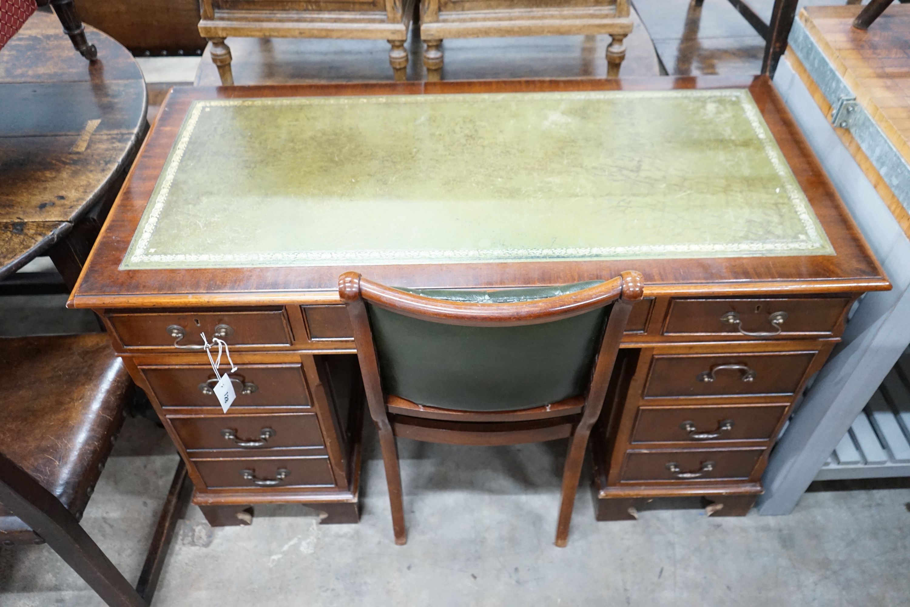 A reproduction mahogany pedestal desk, width 122cm, depth 60cm, height 77cm and chair